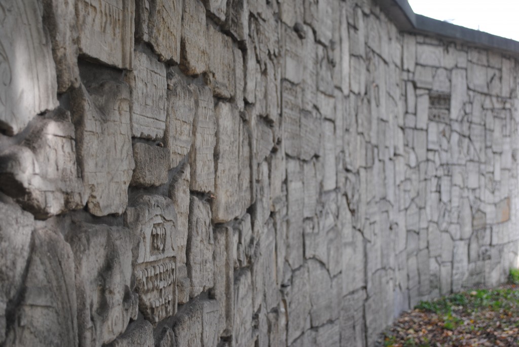 Broken pieces of tombstones that could not be restored have been built into a wall that lines the cemetery.