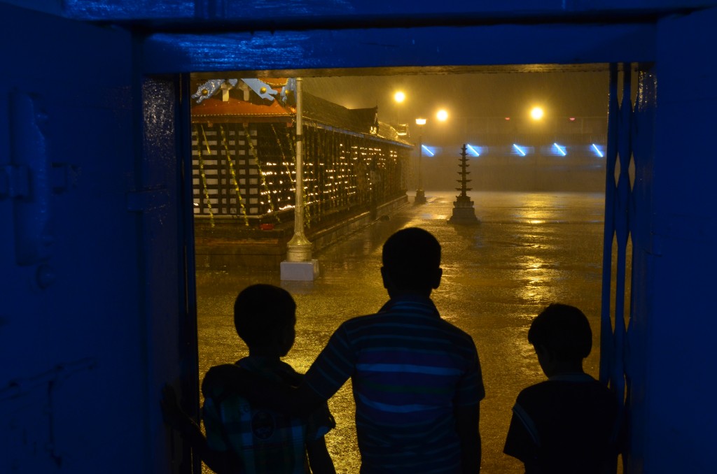 Children watch out the door from our shelter as the rain shows no sign of stopping.