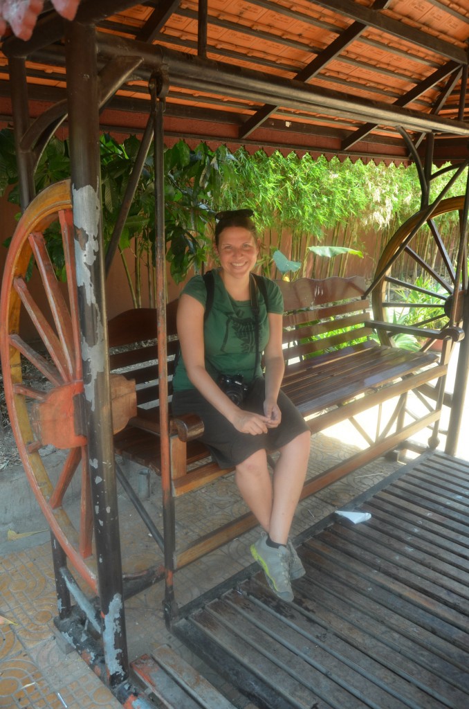 Marisa enjoying a traditional Cambodian swing in front of the temple.